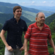 Phillip Gregory, left, stands with his uncle, Bruce Gregory, by a sign off the Blue Ridge Parkway, the design and construction of which Bruce contributed to in the 1960s.