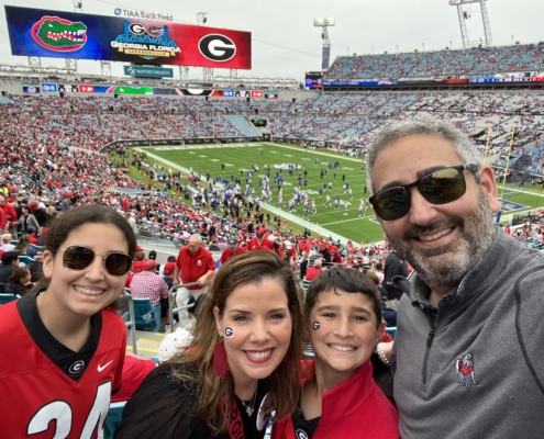 Danelle poses with her family at a Georgia-Florida football game.